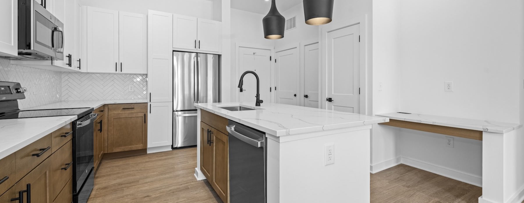 kitchen with wood-style flooring and stainless steel appliances