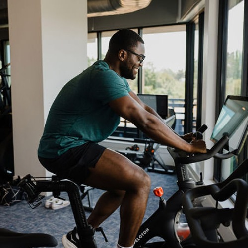 man on exercise bike in fitness center