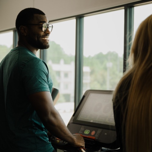 man and woman on treadmill 