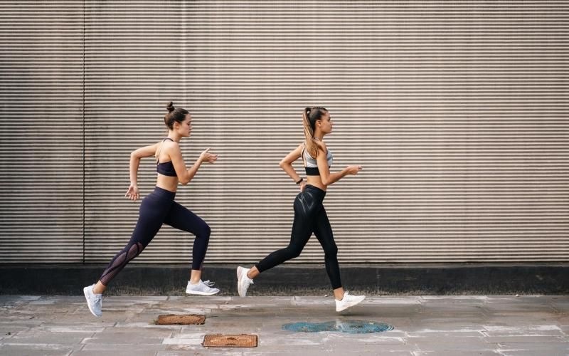 two women running on a street